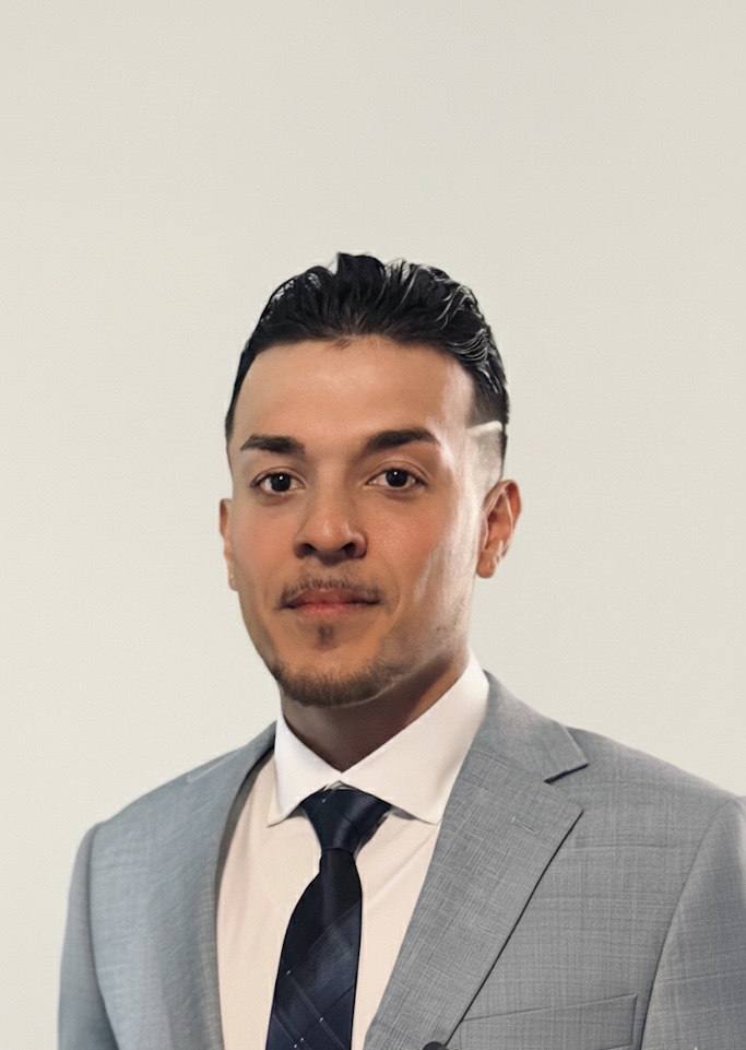 Portrait of Devin Fred in a grey suit
